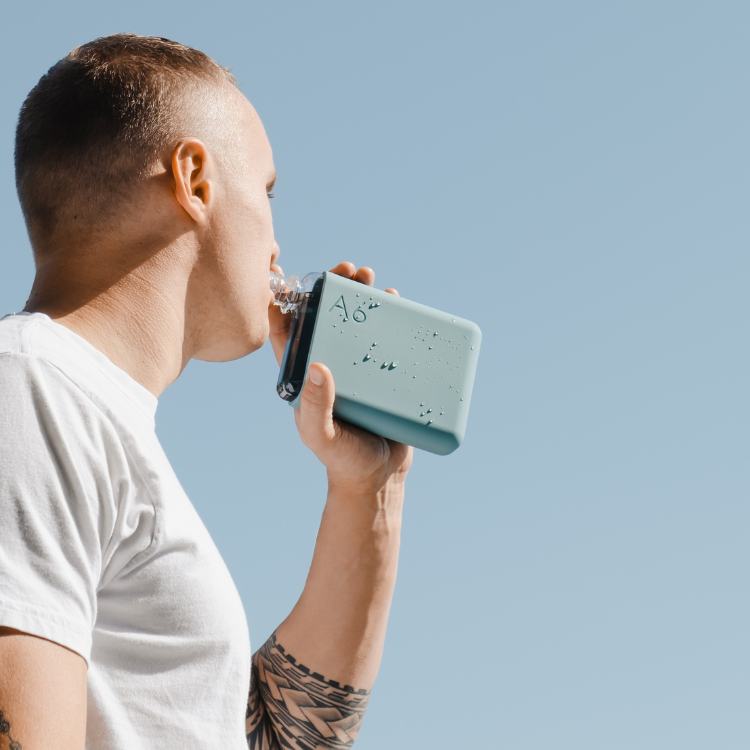 A blue colored A6 Memobottle with a stainless steel lid, designed to fit into handbags or pockets easily