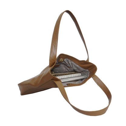 Brown leather laptop handbag with a strap, containing a laptop with a white background