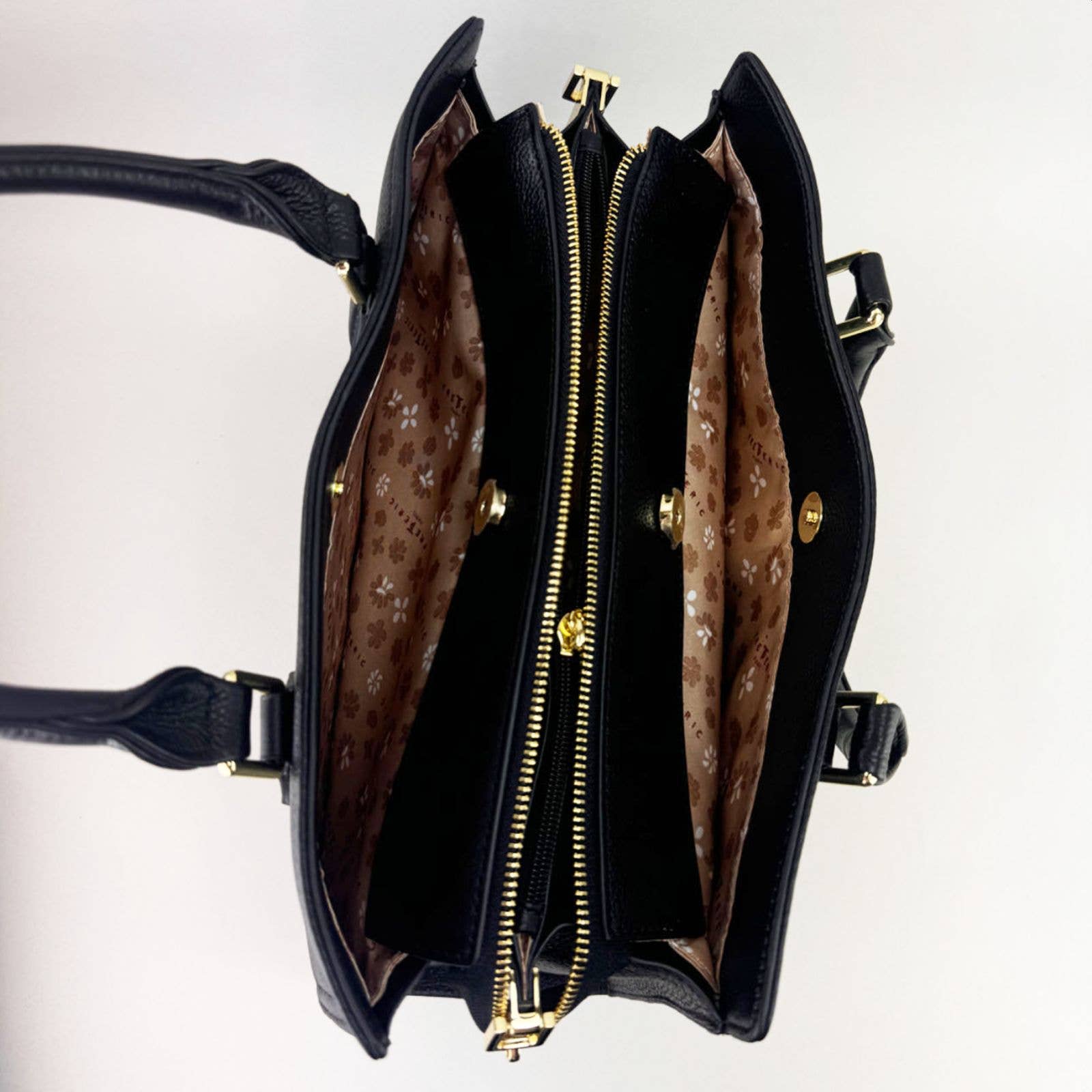 Open black leather laptop handbag with silver accents on a light grey background