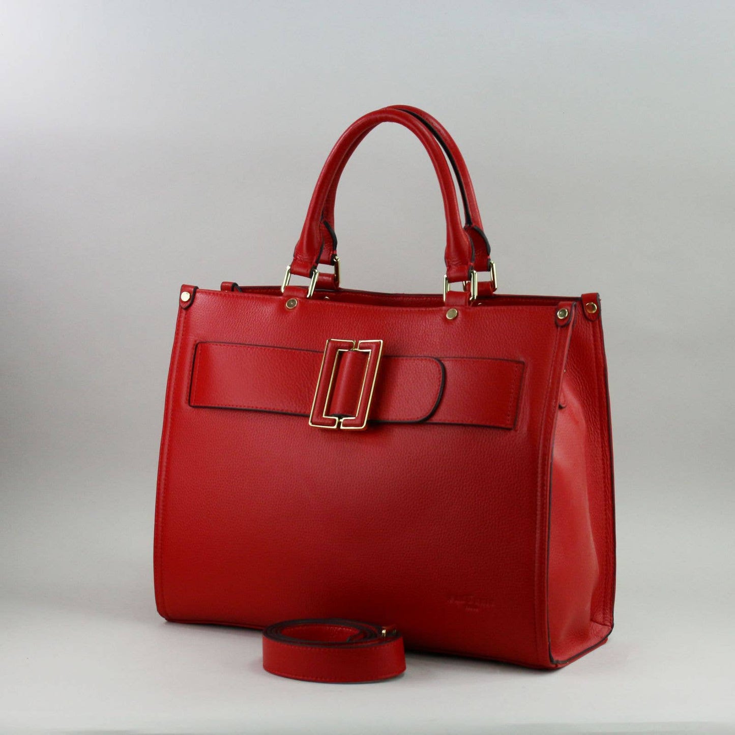 Red leather laptop handbag with a silver buckle on a light grey background